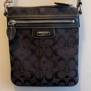 Black COACH crossbody pouch. Beautiful magenta inside. Silver hardware.